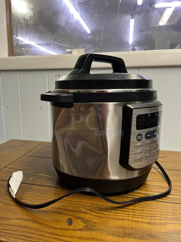 INSIGNIA 6QT rice cooker with 12 programmable settings; stainless steel exterior, digital control panel, model 6 QT.
