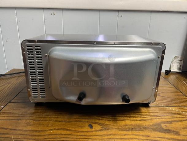 Hamilton Beach 8-Mode Sure-Crisp Air Fry Toaster Oven, model TOASTER OVEN, metal back view. Mint condition, vents visible.