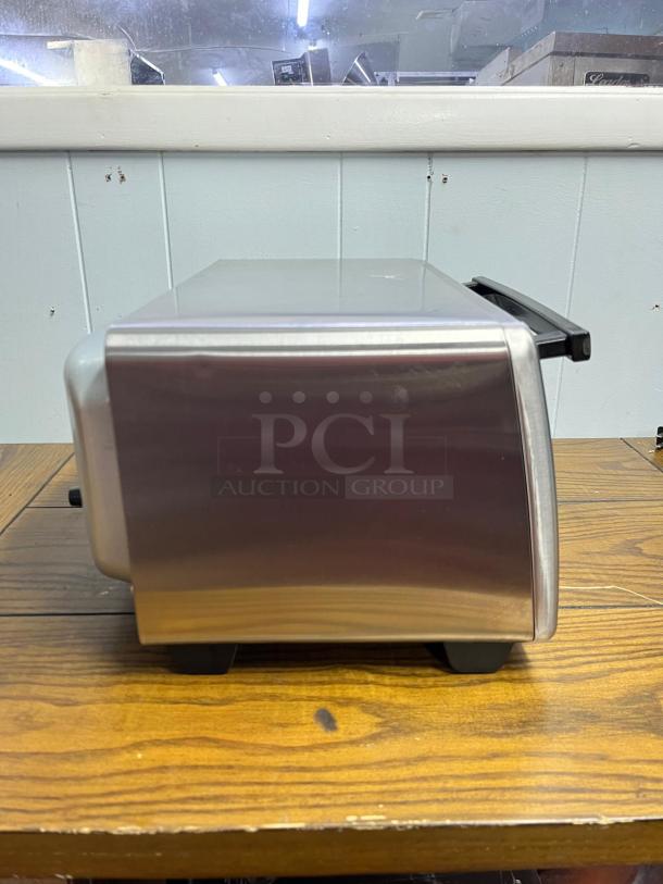 Hamilton Beach 8Mode Sure-Crisp Air Fry Toaster Oven, stainless steel side view, sleek design, gently used condition.