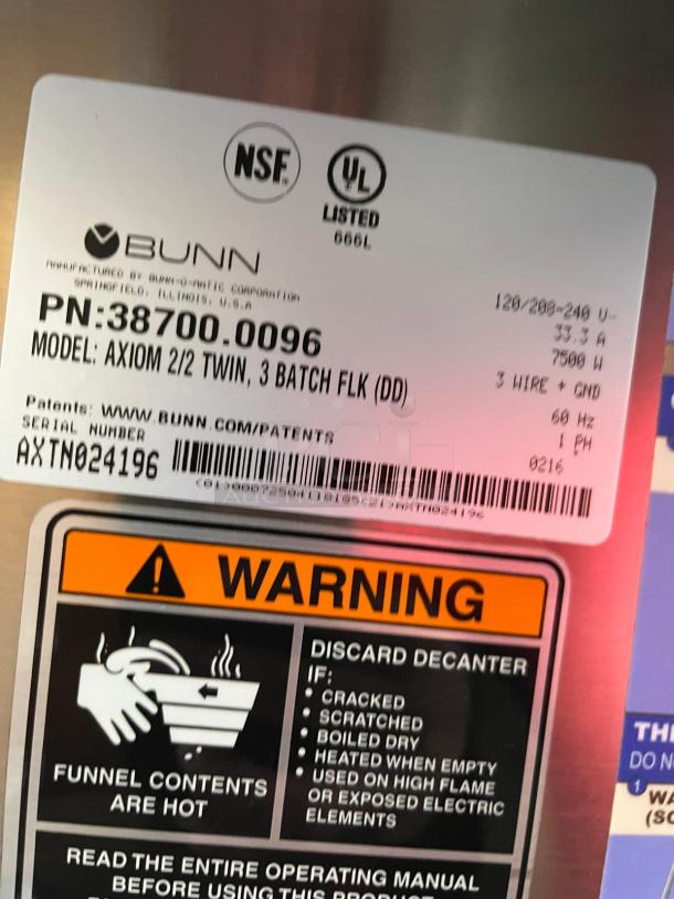 BUNN AXIOM coffee brewer label, model 38700.0096, with warnings and certifications. Dual upper/lower warmers, automatic use.