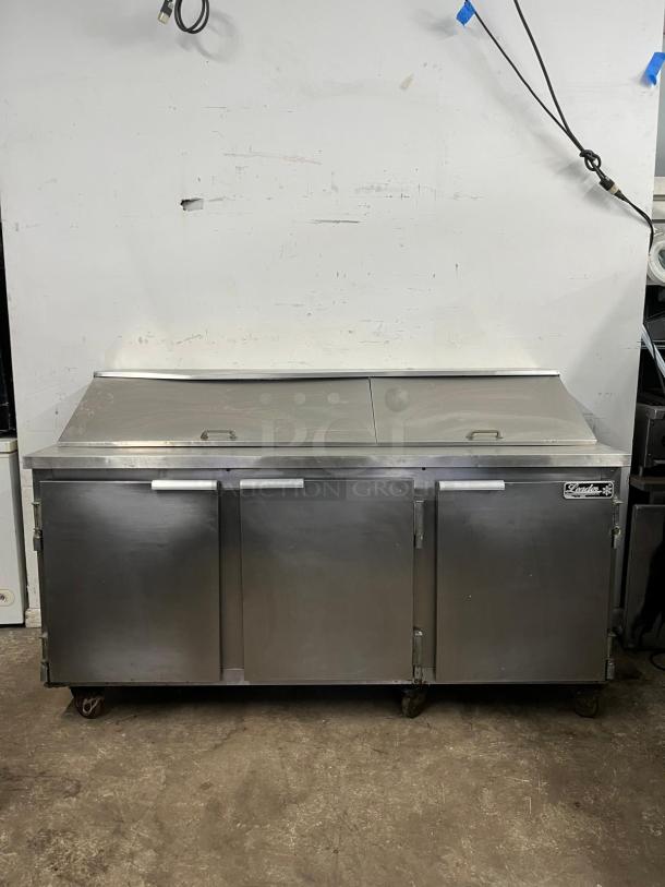 Leader NSFM72 72" 3-door refrigerated prep table, stainless steel, includes mega top for sandwich/salad prep, in good condition.