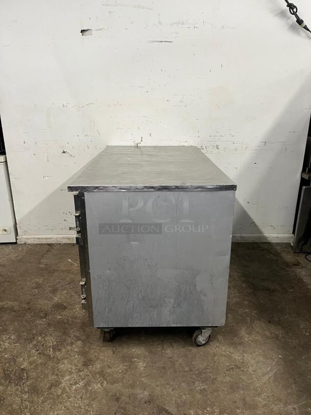 Leader LB60 60" Low Boy Worktop Refrigerator, stainless steel, fair condition, visible wear and caster wheels.