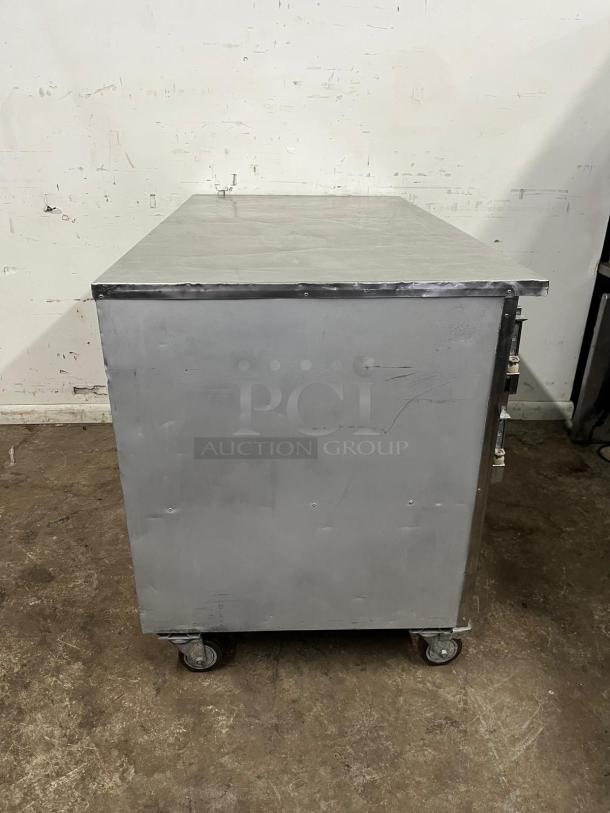 Leader LB60 60" Low Boy Worktop Refrigerator, stainless steel, on caster wheels, used condition, minor surface marks visible.