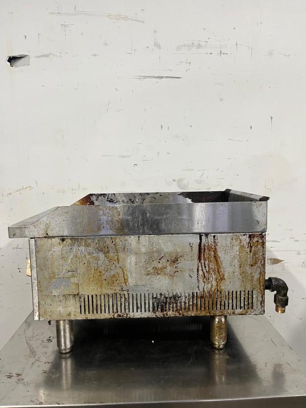 Star-Max 15in radiant gas charbroiler with visible wear and rust, stainless steel, compact countertop design for commercial use.