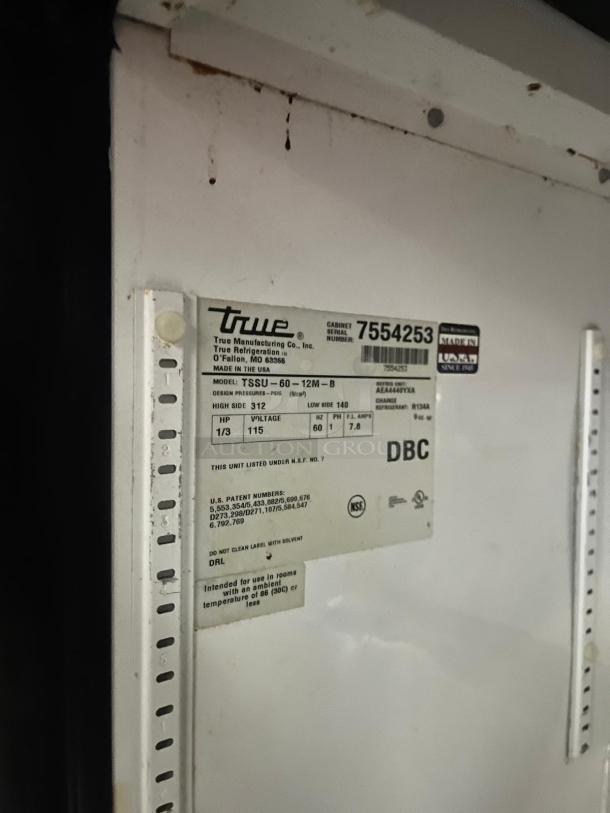 TRUE TSSU-60-12M-B-HC label, showing model, serial number, and specs. Used refrigerated sandwich prep table.