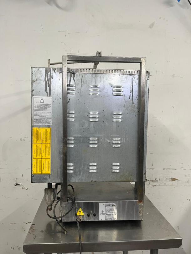 INOKSAN PDG400N Doner Kebab Machine, vertical broiler, natural gas with mesh shield, 132-165 lb. capacity, visible warning labels.