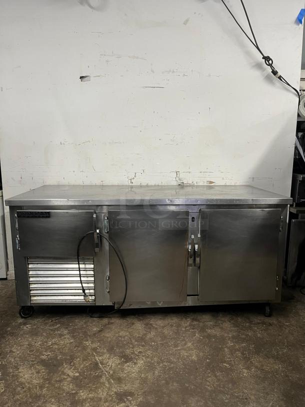 UNIVERSAL COOLER 3 Door Worktop; stainless steel, used condition, industrial, refrigeration system, mobility casters.