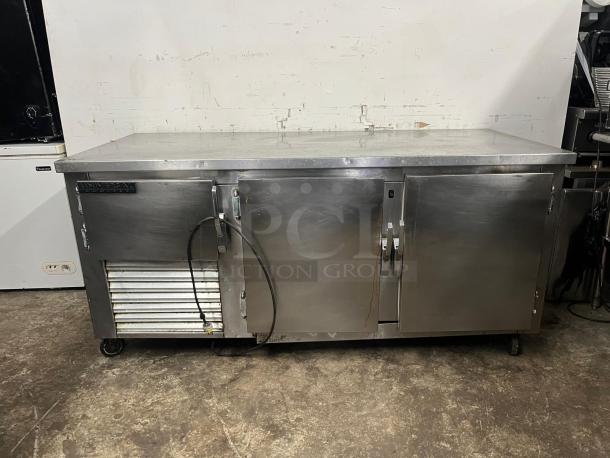 UNIVERSAL COOLER 3 Door Worktop, stainless steel, caster wheels, electrical components visible, used condition.