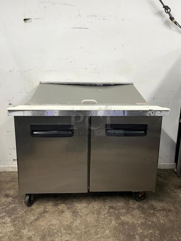 Blue Air BLMT48-HC, 48" sandwich prep table, stainless steel, two swing doors, used condition, on casters.