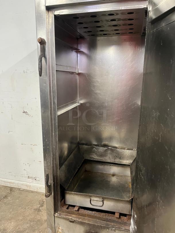 UNIVERSAL Smoker Oven, galvanized interior, 3 burners, 78" height. Features open door view and metal shelves. Used condition.