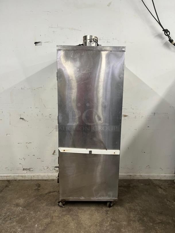 UNIVERSAL Smoker Oven, 78" with galvanized interior. Features 3 burners, stainless steel exterior. Appears used, on wheels.
