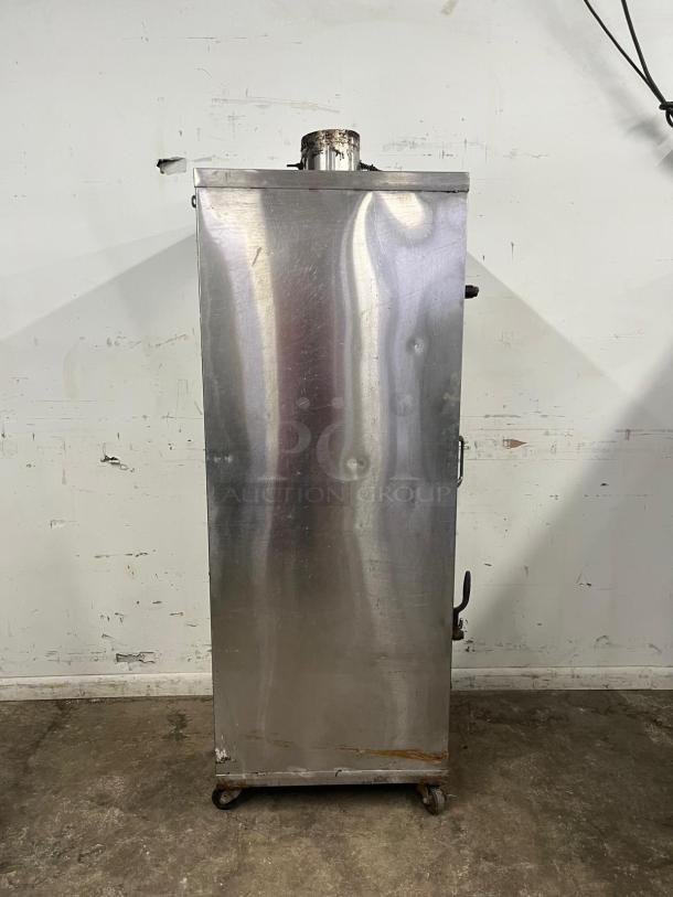 Universal Smoker Oven, galvanized interior, 3 burners, 78" tall. Visible wear, rusty bottom, model SMOKER by UNIVERSAL.