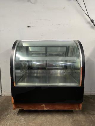 36" curved refrigerated display case with glass front, black finish, two shelves. Visible wear on bottom edges.