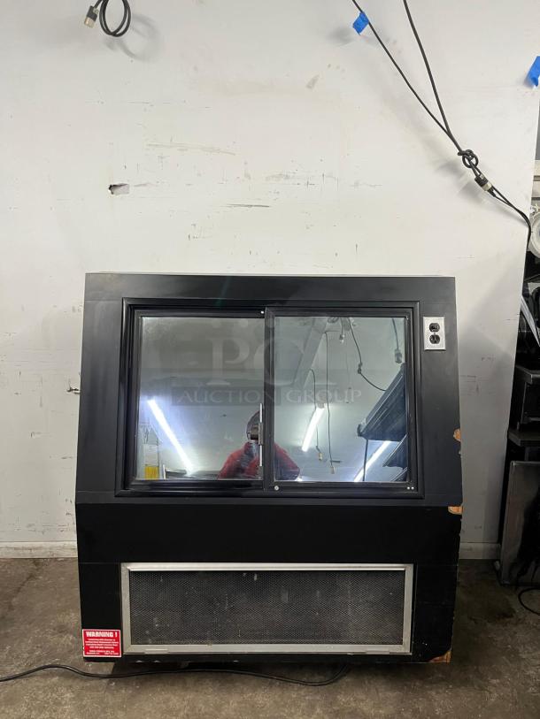 36" curved refrigerated display case in black, featuring dual glass doors and a visible warning label. Good condition.