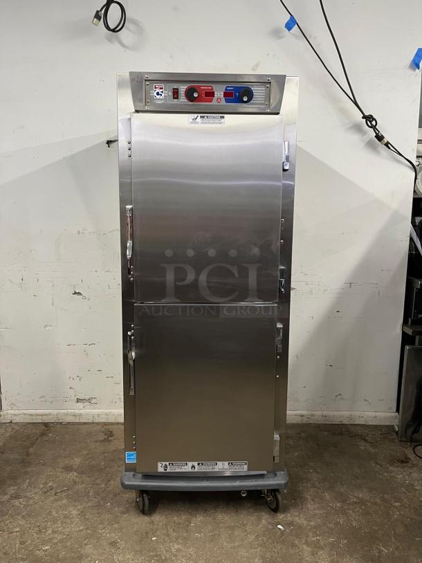 METRO C599-SDS-U heated holding/proofing cabinet, stainless steel, solid Dutch doors, full-size, on casters.