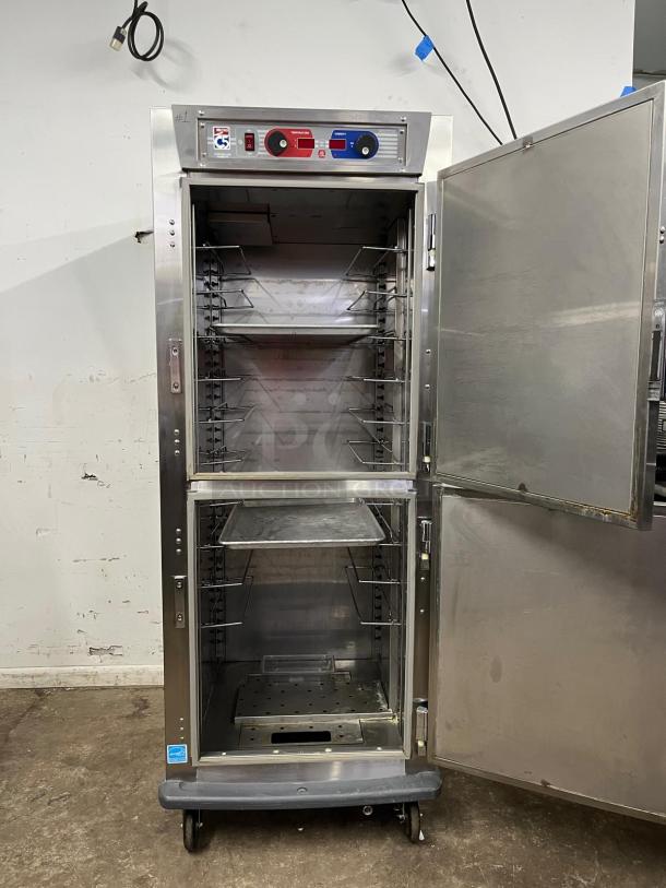 METRO C599-SDS-U C5 9 Series heated holding/proofing cabinet, solid Dutch doors, stainless steel, clean, on wheels.