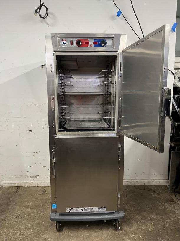 Metro C599-SDS-U C5 9 Series heated holding cabinet, solid Dutch doors, stainless steel, shown open with racks inside.