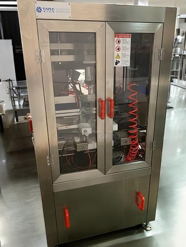 Tang Semi-Automatic Four-Station Vacuum Capper, premium condition, stainless steel, red handles, safety labels visible.
