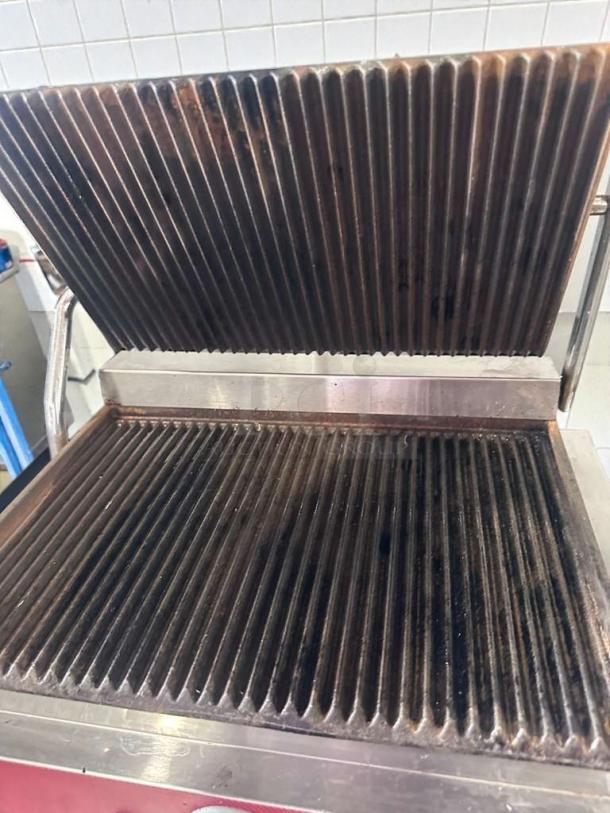 Adcraft countertop panini grill in excellent condition, stainless steel, UL listed, fully tested, ribbed plates visible.