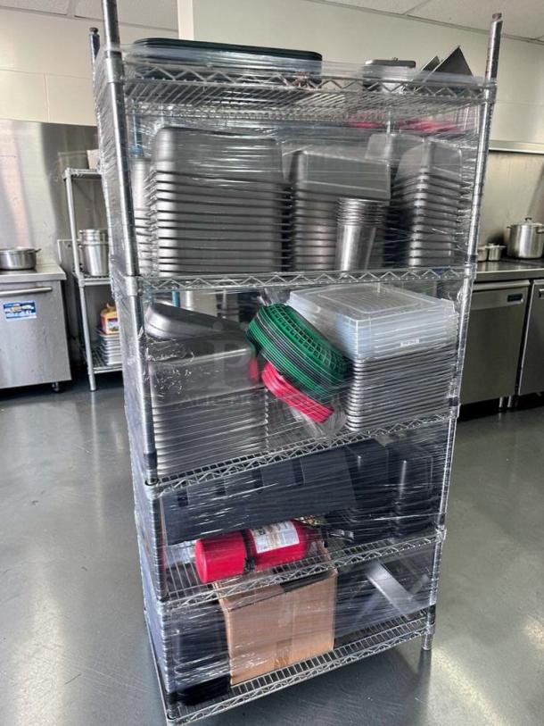 4-tier NSF chrome wire shelving rack, 36x18 in, with stacked food pans and accessories, fully inspected, premium condition.