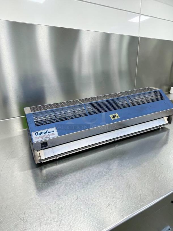 Superb Condition 36" Curtain Products IBD-2-36-1-SS commercial air curtain, UL listed, fully tested, on metal surface.