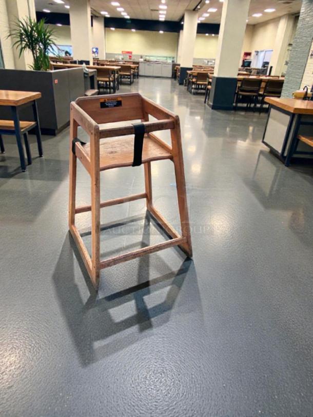 Commercial wooden restaurant high chair, in prime condition, heavy-duty build, with safety strap, inspected and ready for service.