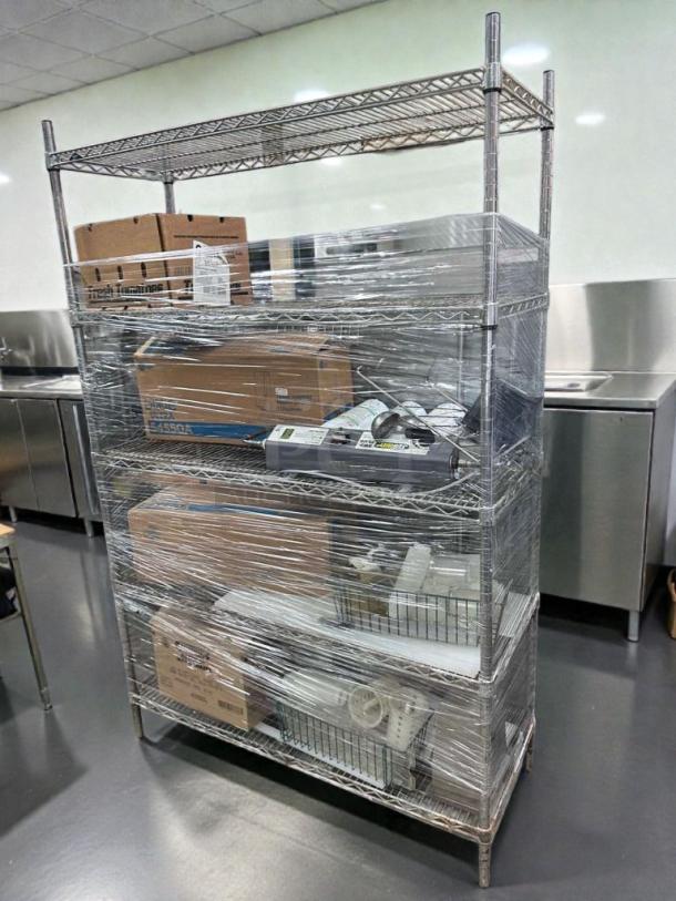 Commercial chrome wire shelving rack wrapped with assorted restaurant contents, top-tier condition, inspected and ready for use.