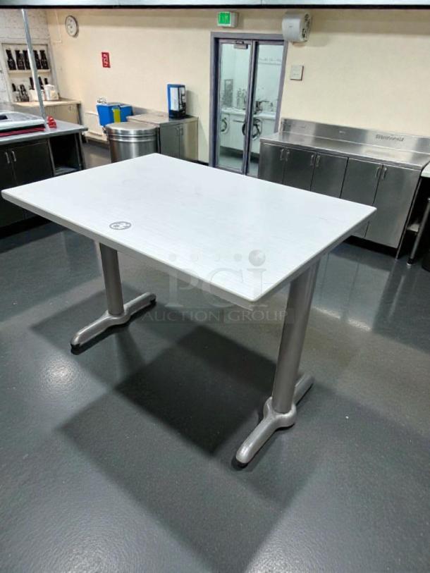 Commercial restaurant dining table with laminate top, heavy-duty metal base, superior condition, inspected, ready for use.