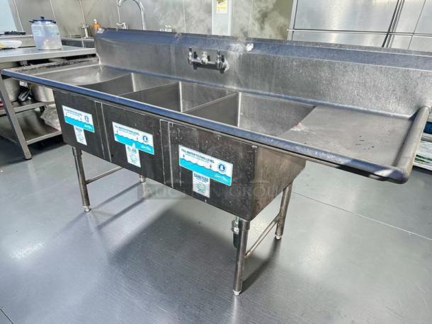 Immaculate 3-compartment stainless steel sink by Commercial Stainless Steel Fabrication, dual drainboards, NSF-certified.