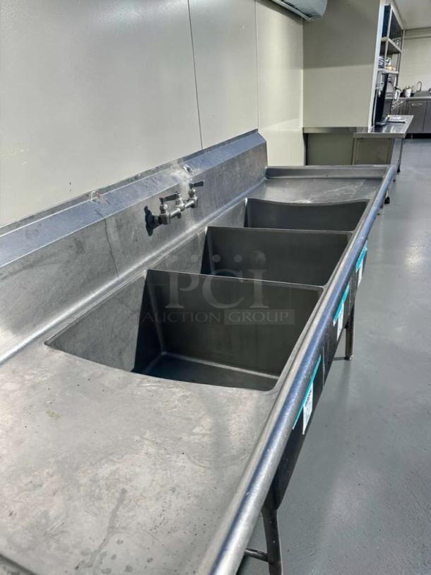 Immaculate 3-compartment stainless steel sink with dual drainboards, NSF-certified, by Commercial Stainless Steel Fabrication.