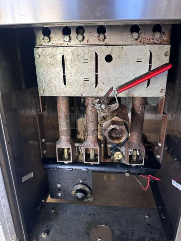 Frymaster commercial gas fryer interior, showing metal and gas components; prime condition, heavy-duty stainless steel model.