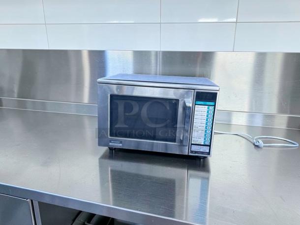 Sharp R-22GT commercial microwave oven, 1200W, stainless steel, superb condition, fully tested, 120V, visible control panel.