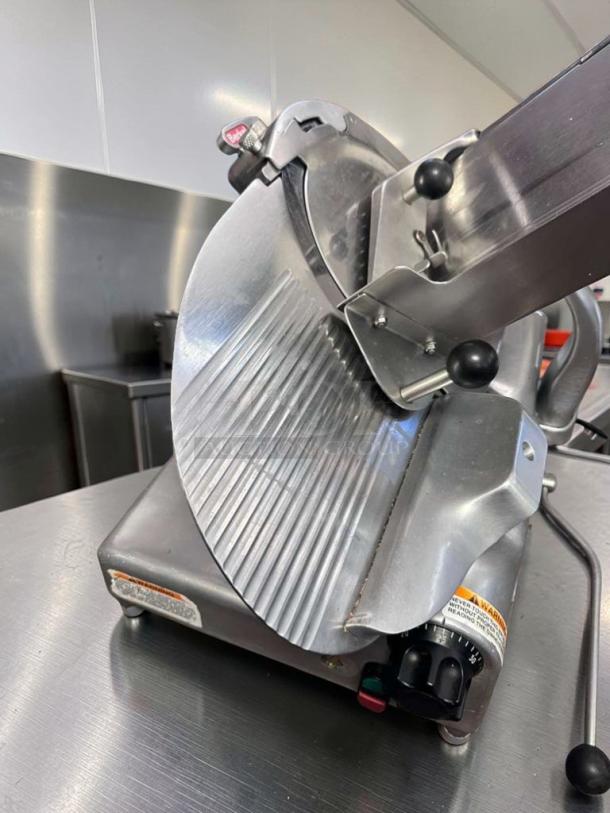Berkel 909/1 commercial manual meat slicer in immaculate condition, 115V, NSF certified, fully operational, stainless steel finish.