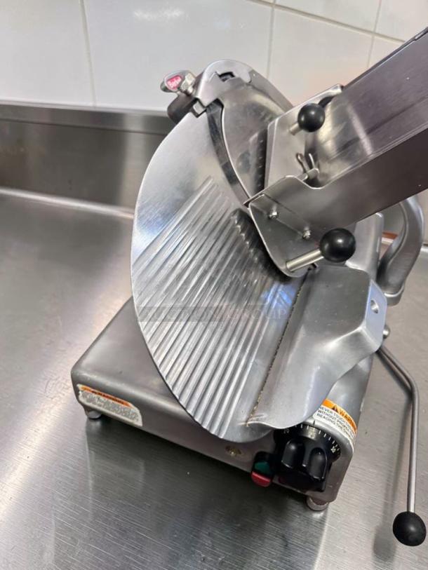 Berkel 909/1 commercial manual meat slicer, heavy-duty, in immaculate condition, 115V, NSF certified, fully tested.
