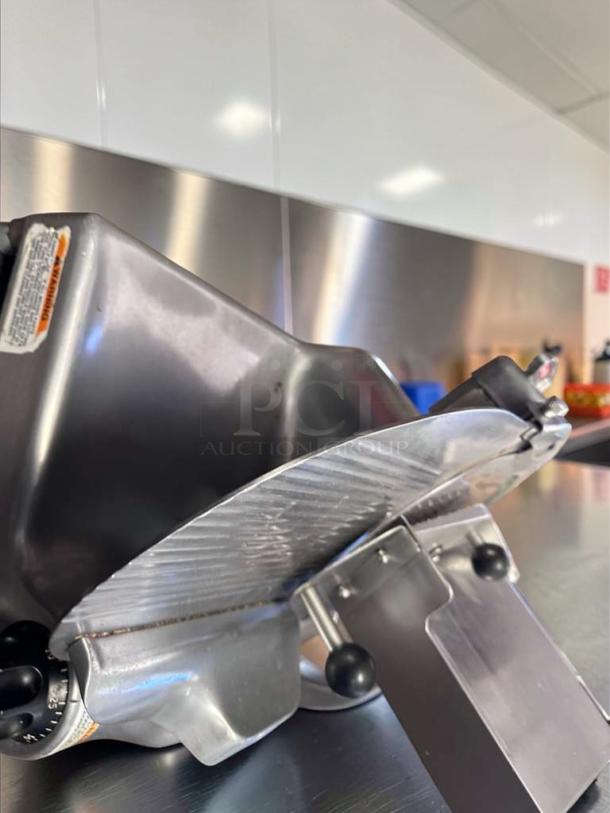 Immaculate Berkel 909/1 commercial meat slicer, heavy-duty, stainless steel, 115V, NSF certified, fully operational.