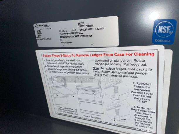 Structural Concepts SB2755 refrigerated bakery display case label showing 220V, single phase, NSF certified.