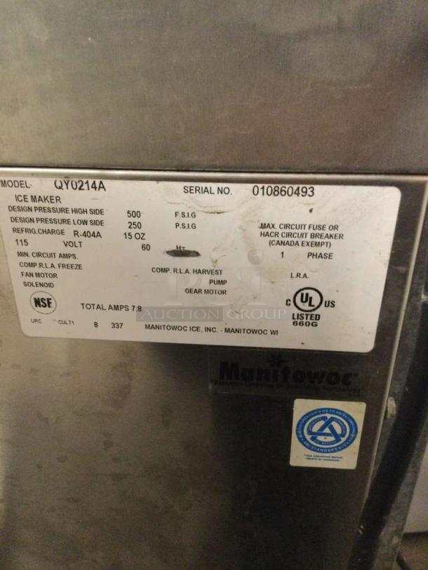 Manitowoc QY0214A commercial ice maker, 115V, single-phase, pristine condition. Features include fully tested functionality. Model and serial numbers visible. Tags display certifications and specifications.