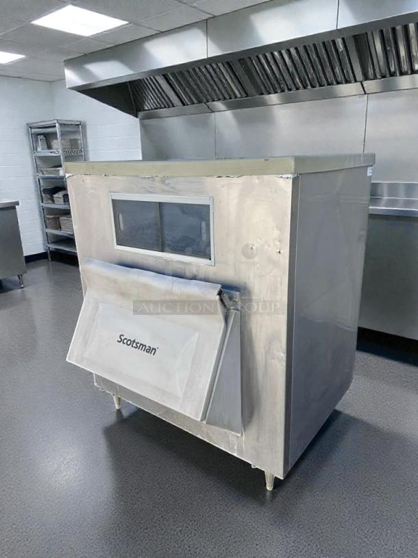 Immaculate Scotsman BH1100BB-A ice storage bin, NSF certified, inspected. Stainless steel finish with Scotsman logo, excellent condition.