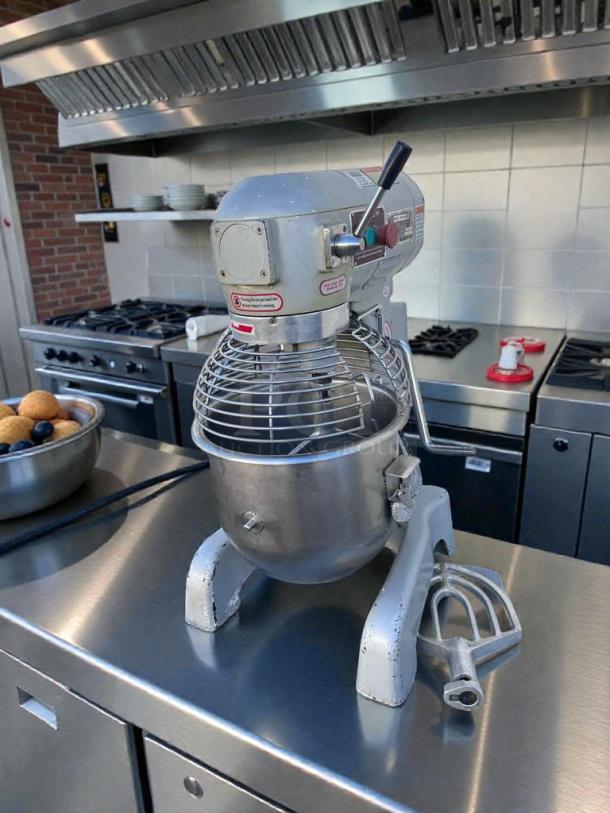 Commercial UPM-M20-3 20 Qt planetary mixer in superior condition, 110V, fully tested and working, in a stainless steel kitchen.