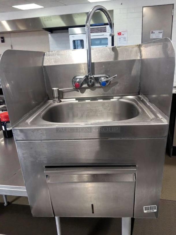 Commercial stainless steel hand wash sink with gooseneck faucet, built-in paper towel dispenser; high-grade condition.