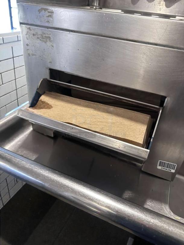 Commercial stainless steel hand wash sink with gooseneck faucet, built-in paper towel dispenser. High-grade condition, fully operational.