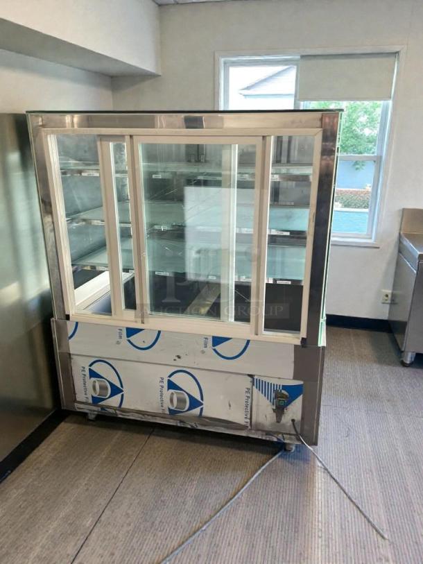Immaculate condition glass display case, 115V single phase, fully tested, stainless steel frame, sliding doors, protective film.