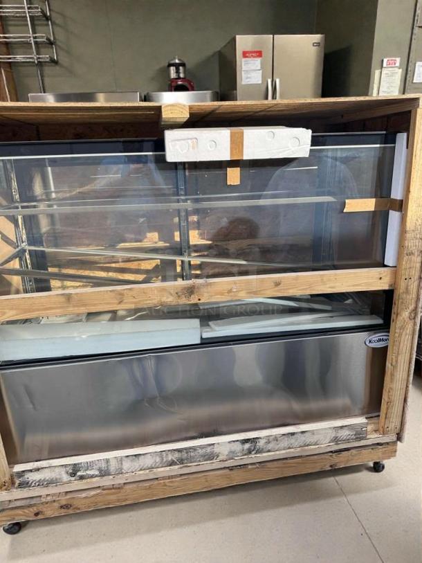 Brand new KoolMore Refrigerated Bakery Display Case, model KML-L-BDC-0031, in scratch & dent condition, crated for transport.