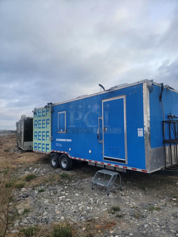 Rock Solid Cargo 24' mobile kitchen trailer, blue, dual-axle, needs cleaning. Features Arctic Air fridge, Wells griddle, exhaust hood.