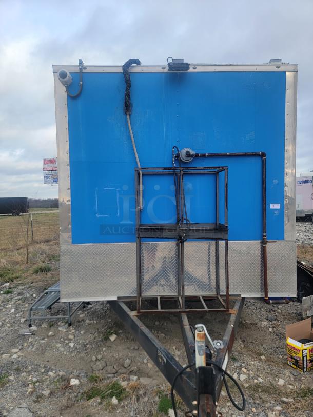 24' Rock Solid Cargo mobile kitchen trailer, blue exterior, dual-axle. Features Arctic Air fridge, Wells griddle, CaptiveAire hood. Needs cleaning.
