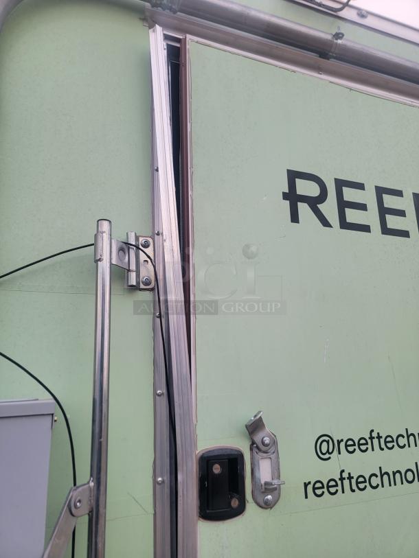 Rock Solid Cargo 24' mobile kitchen trailer, side view. Features dual axles, visible wear, needs cleaning. Branding: @reeftech, reeftechnology.
