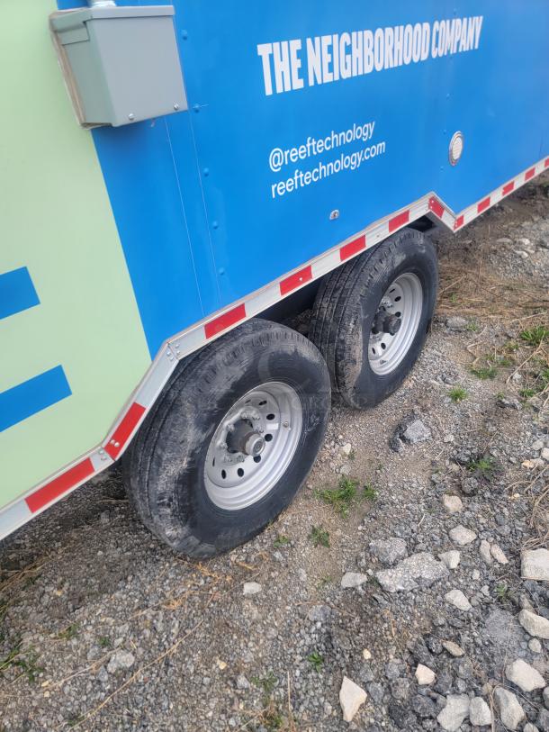 Rock Solid Cargo 24' food trailer, blue with logos, dual-axle, parked on gravel. Needs cleaning. VIN: 573BE2421MF033749.