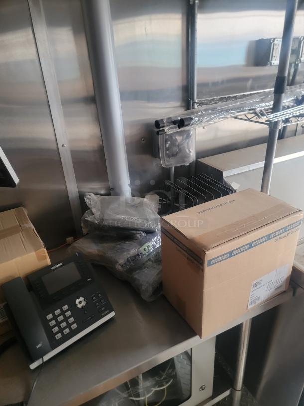 Rock Solid Cargo 24' mobile kitchen interior with stainless steel surfaces, phone, and boxed items. Needs cleaning, VIN: 573BE2421MF033749.