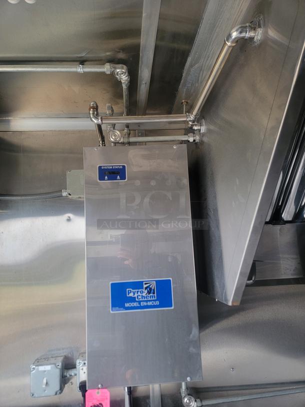 Rock Solid Cargo 24' mobile kitchen trailer interior showing Pyro-Chem Model EN-MCU3 system, requiring cleaning for use.