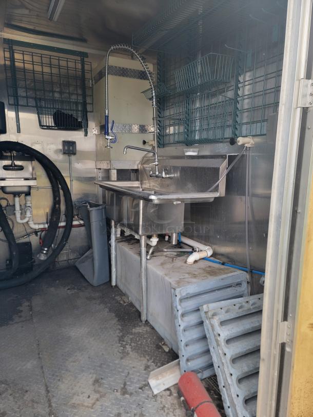 Interior of 2020 Diamond Cargo mobile kitchen, featuring stainless steel wash and prep station. Unit needs cleaning.